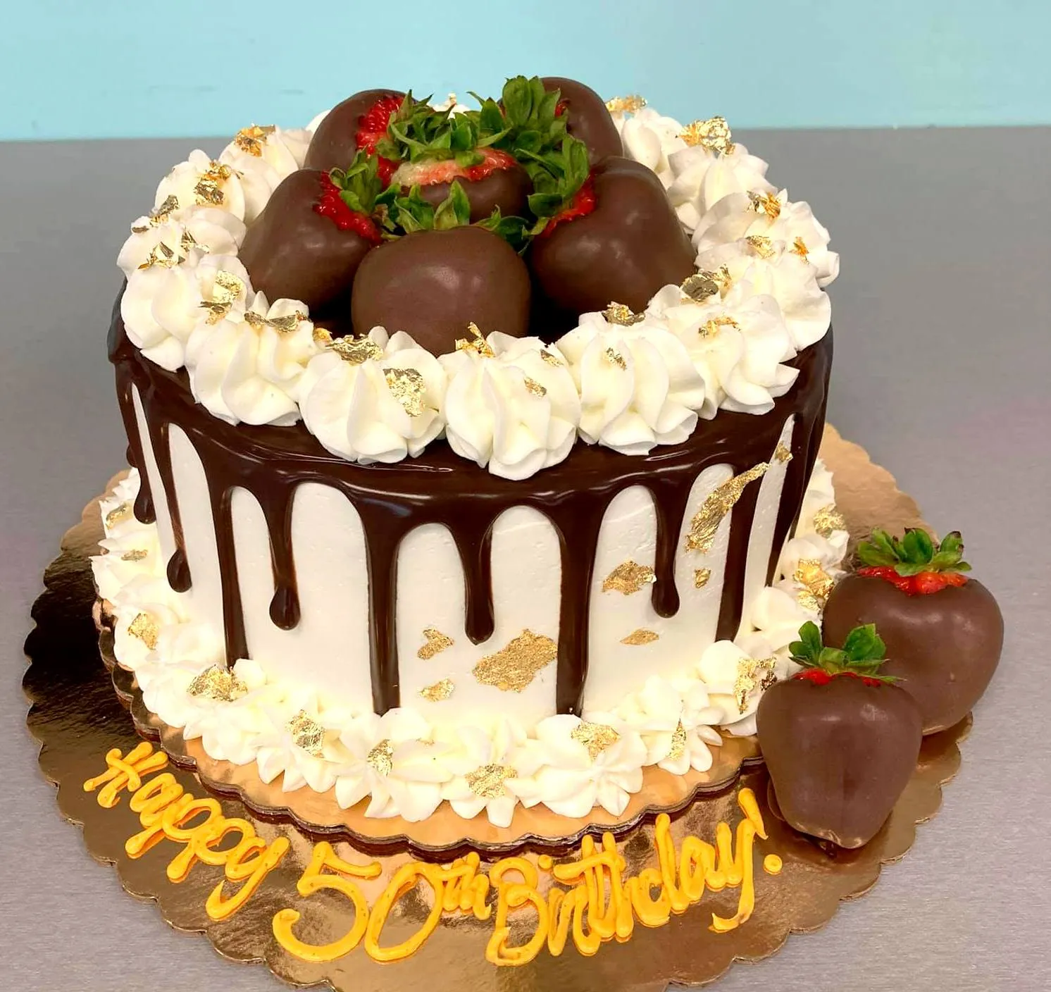 Gold Drip Cake with Sugar Magnolias and Strawberries