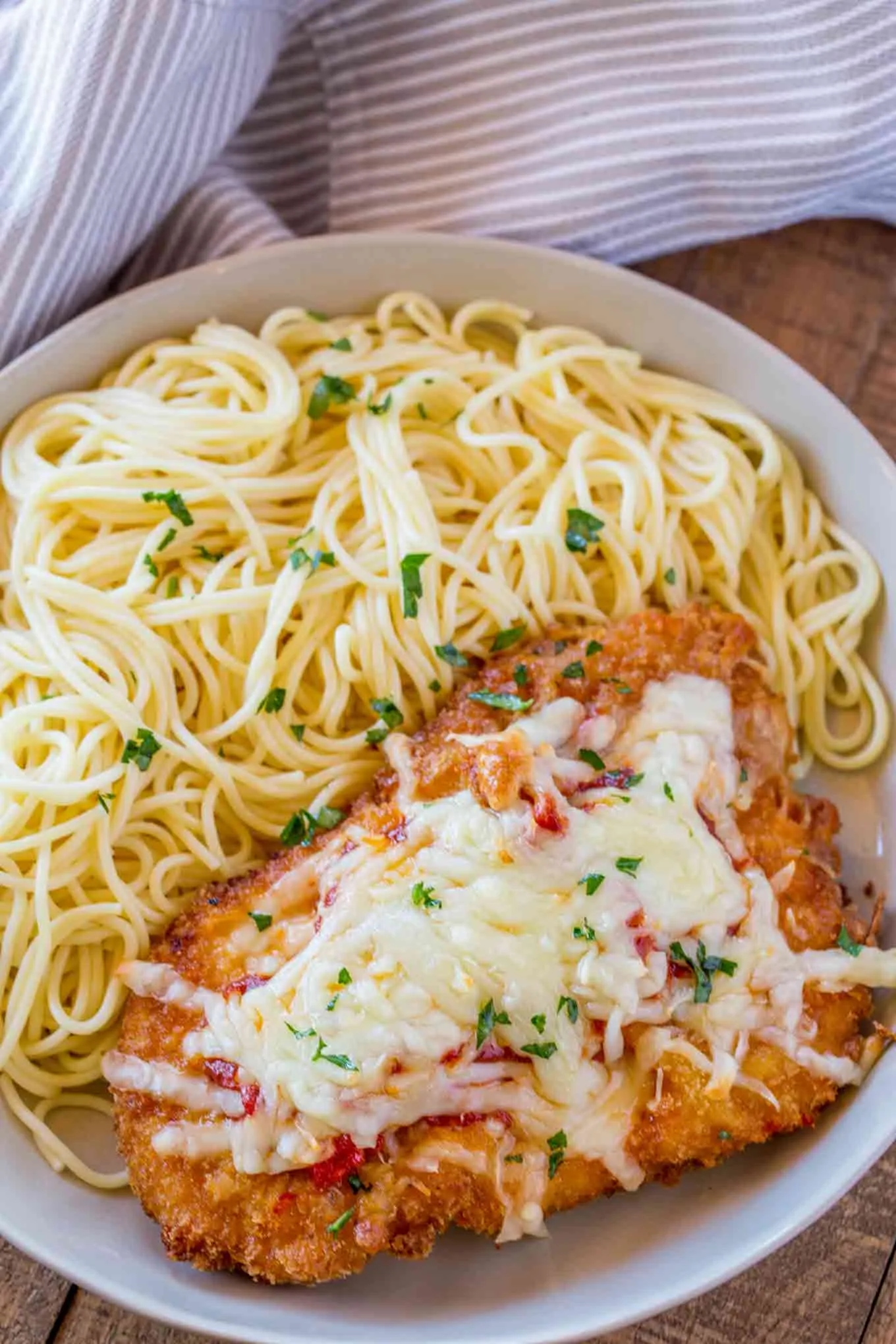 Parmesan Crusted Chicken Tenders Over Pasta with Cream Sauce