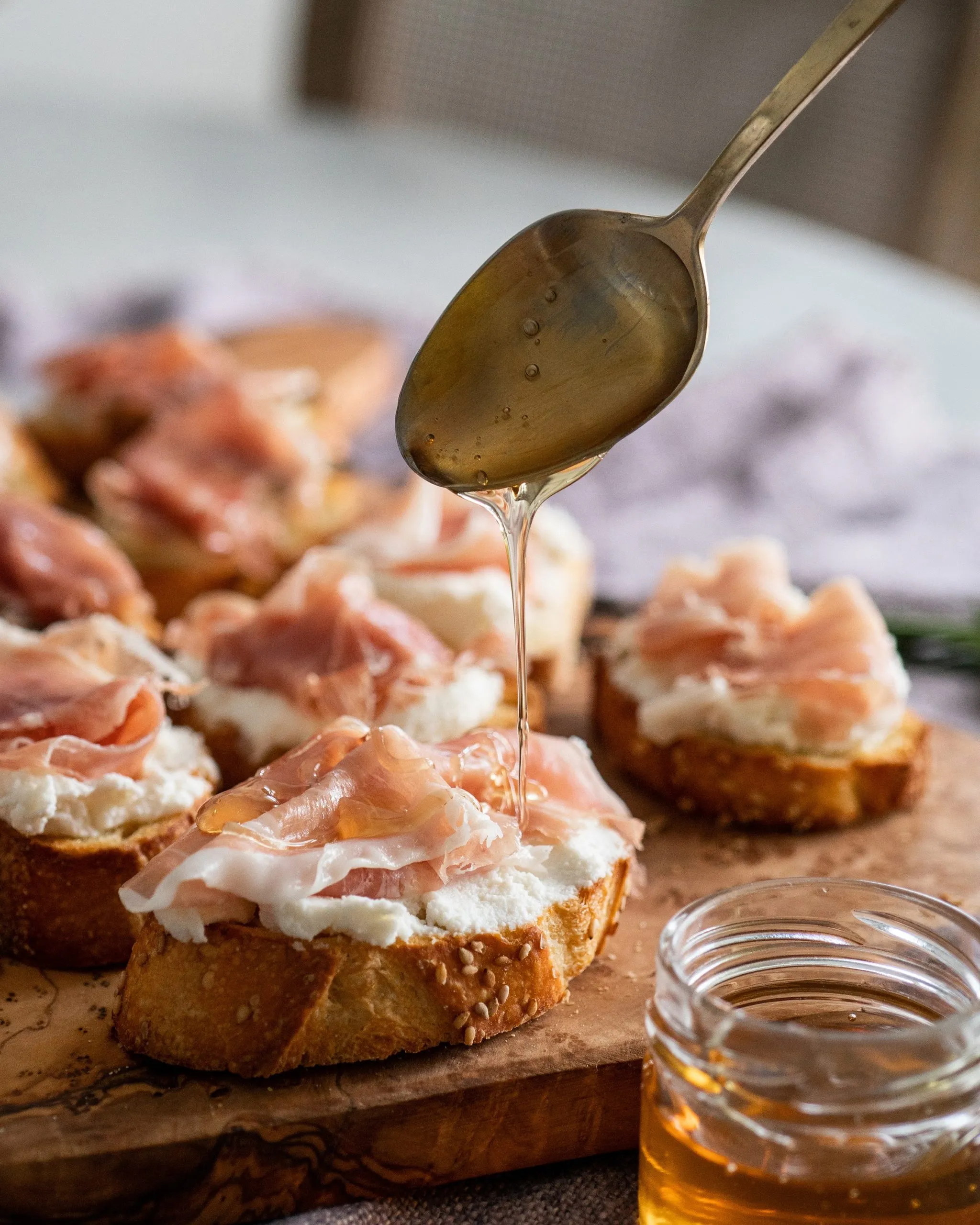 Prosciutto Crostini with Ricotta, Arugula, and Honey